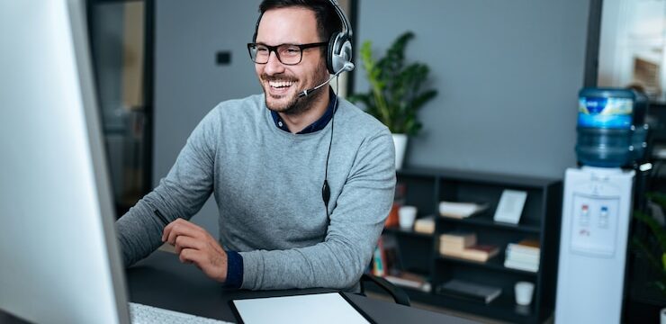 portrait-handsome-smiling-man-with-headset-working-computer_109710-614